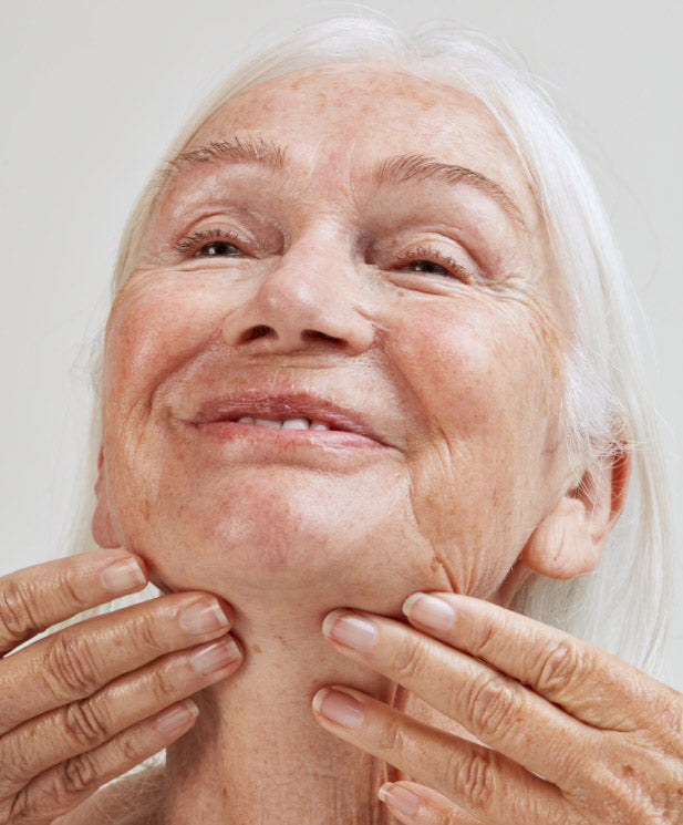mature woman applying skincare